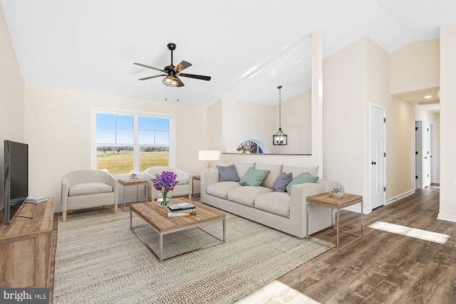 living room featuring hardwood / wood-style flooring, ceiling fan, and lofted ceiling