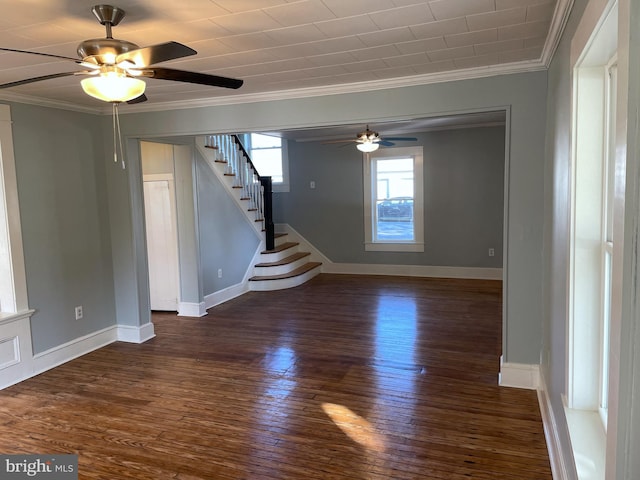 empty room with dark wood-type flooring, crown molding, and ceiling fan