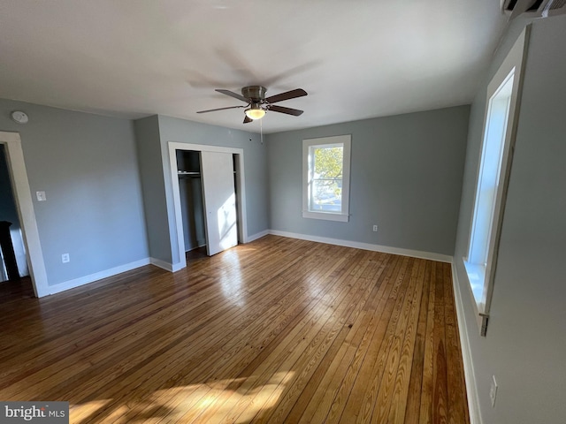 unfurnished bedroom with a closet, hardwood / wood-style floors, and ceiling fan