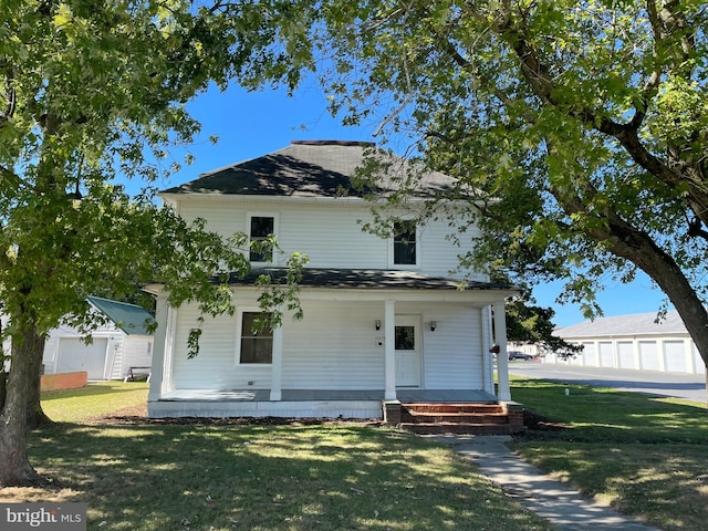 back of house featuring a porch, a garage, and a lawn