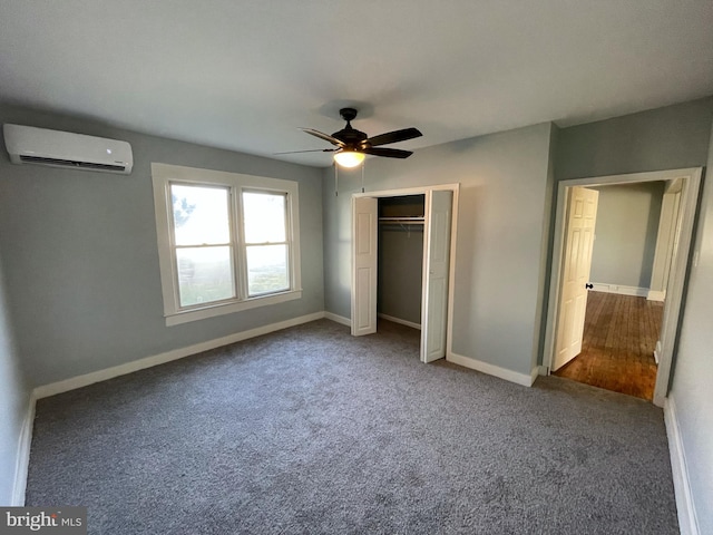 unfurnished bedroom with a closet, carpet floors, an AC wall unit, and ceiling fan