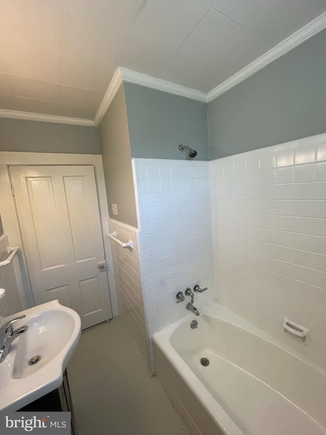 bathroom with vanity, shower / washtub combination, tile walls, and crown molding