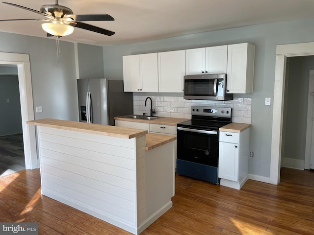 kitchen featuring white cabinetry, stainless steel appliances, and hardwood / wood-style flooring