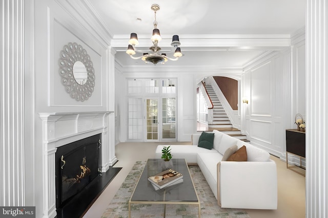 living room with an inviting chandelier and crown molding