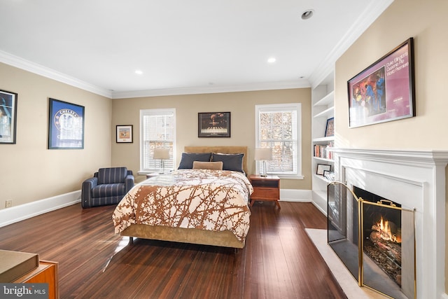 bedroom featuring dark hardwood / wood-style flooring, crown molding, and multiple windows