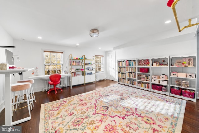 recreation room with dark hardwood / wood-style floors and radiator