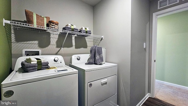 washroom featuring washer and dryer and dark hardwood / wood-style flooring