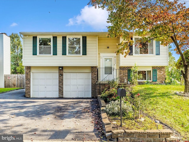 split foyer home with a front yard and a garage