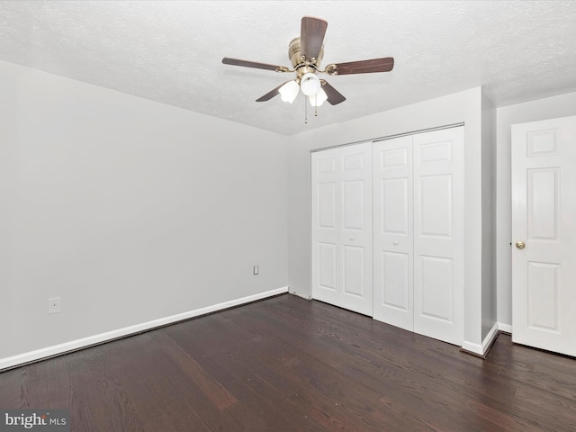 unfurnished bedroom featuring a textured ceiling, ceiling fan, a closet, and dark hardwood / wood-style flooring