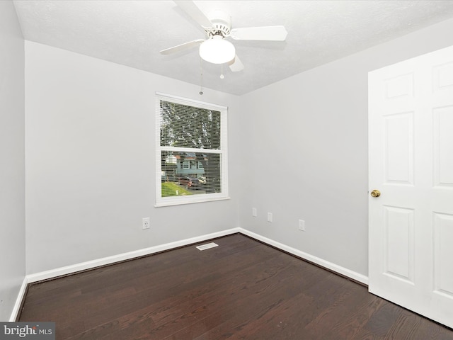 unfurnished room with ceiling fan, dark hardwood / wood-style floors, and a textured ceiling