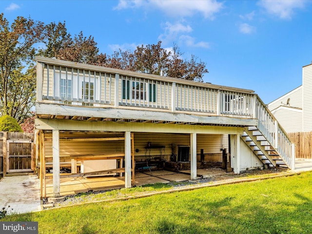 back of house with central air condition unit, a patio, a yard, and a deck