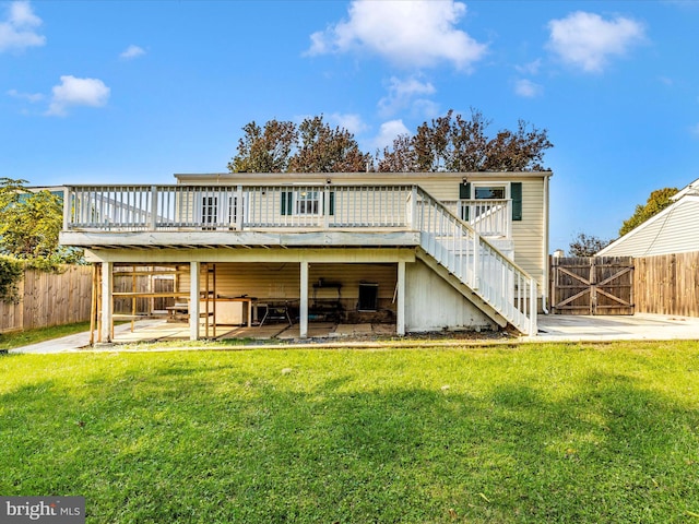 rear view of property with a patio, a yard, and a deck