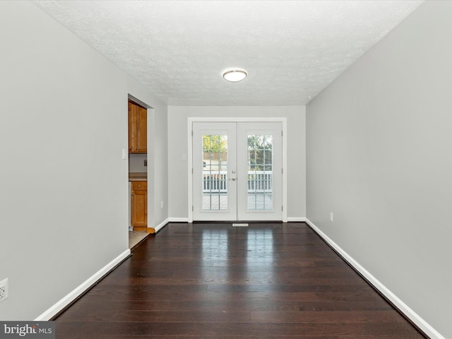 interior space with french doors, dark hardwood / wood-style floors, and a textured ceiling