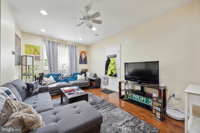 living room with hardwood / wood-style flooring and ceiling fan