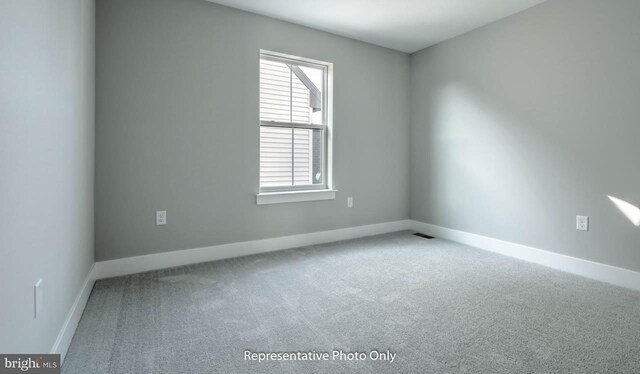 unfurnished room featuring carpet