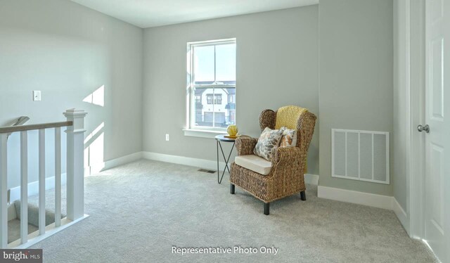 living area featuring light colored carpet