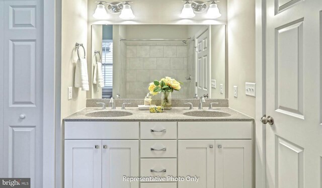 bathroom with a shower and vanity