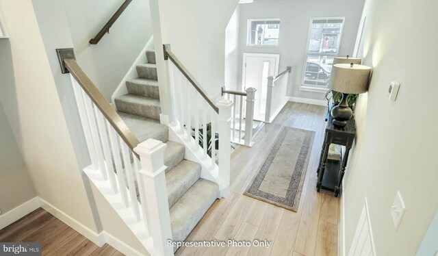 stairway with hardwood / wood-style flooring