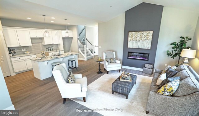 living room featuring light hardwood / wood-style flooring and sink