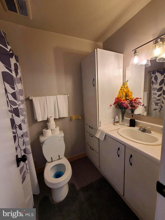 bathroom featuring toilet and vanity