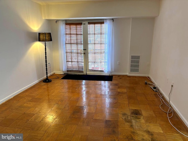 empty room with parquet flooring and a wealth of natural light