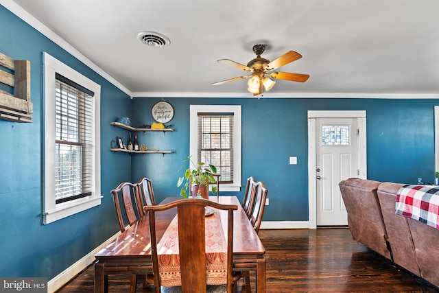 dining area featuring ornamental molding, dark wood-type flooring, and ceiling fan