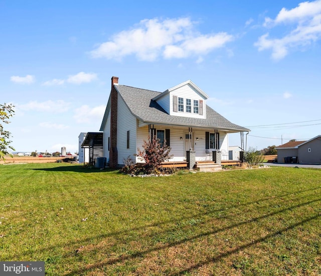 view of front of house featuring central air condition unit, a front lawn, and covered porch