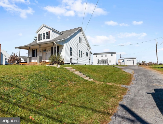 view of front of property with a porch, a front lawn, and a garage