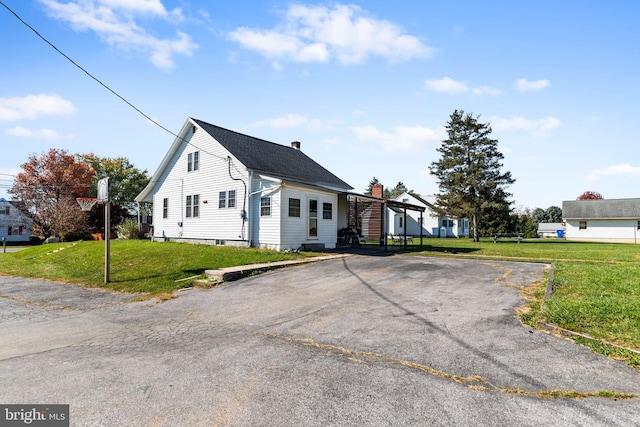 view of property exterior with a yard