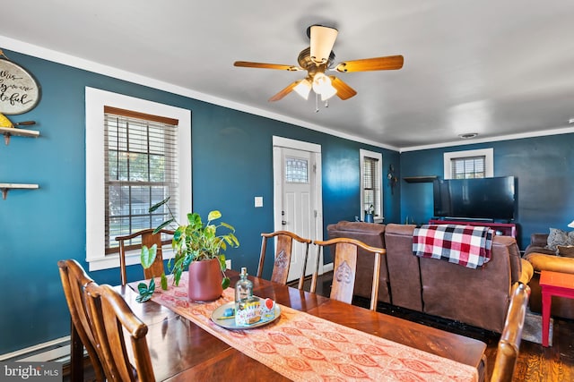 dining room featuring ornamental molding, a baseboard heating unit, hardwood / wood-style flooring, and ceiling fan