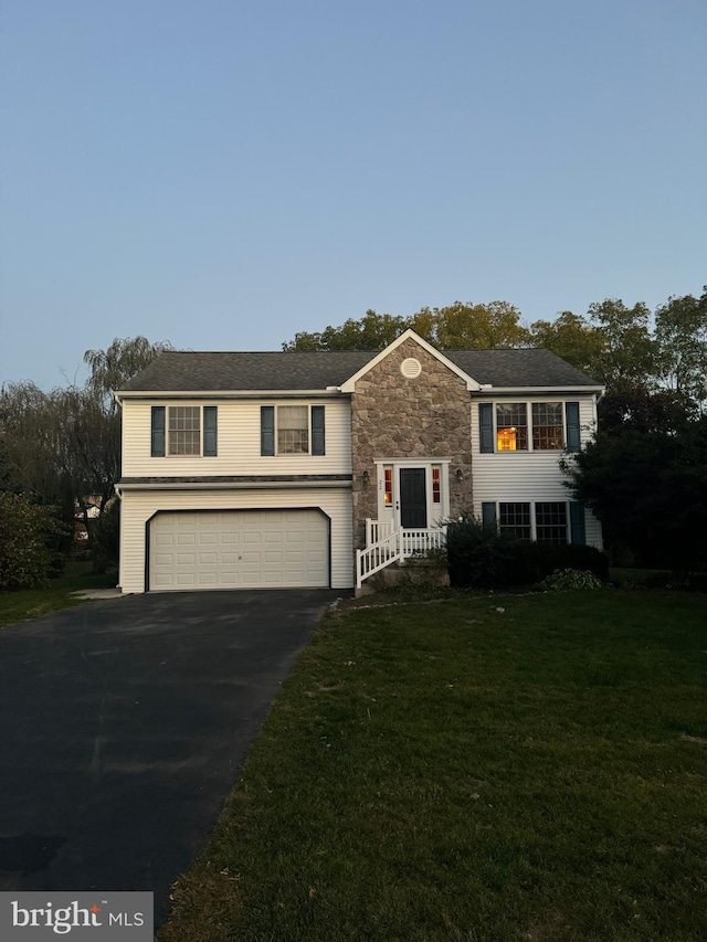 bi-level home featuring a front yard and a garage