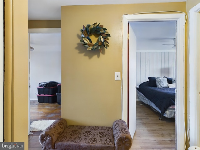 hall with light hardwood / wood-style flooring and ornamental molding