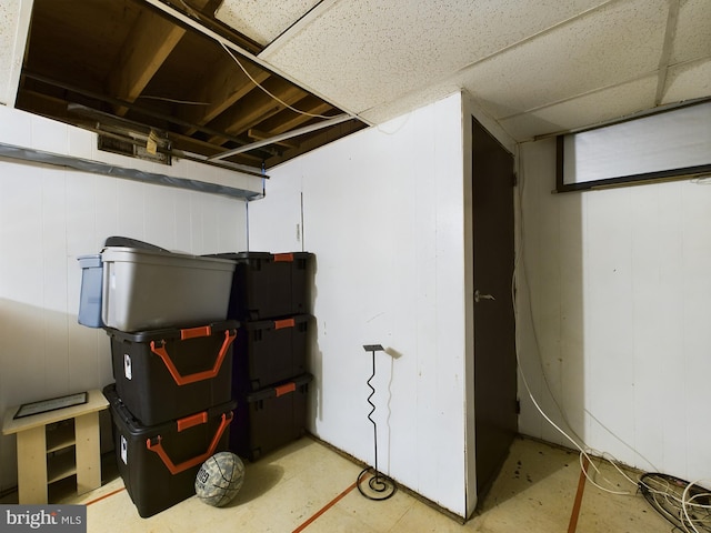 basement featuring a drop ceiling