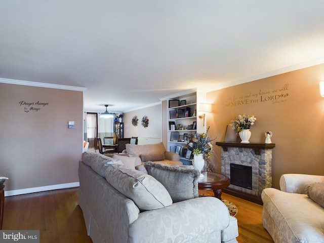 living room with a fireplace, ornamental molding, and hardwood / wood-style floors