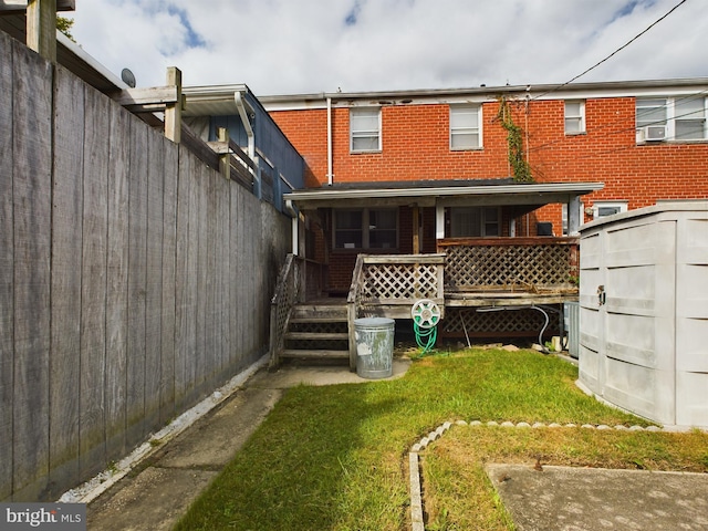 back of property featuring a yard, a shed, and central air condition unit