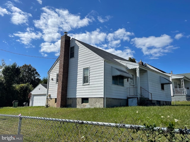 view of home's exterior with a garage and a yard