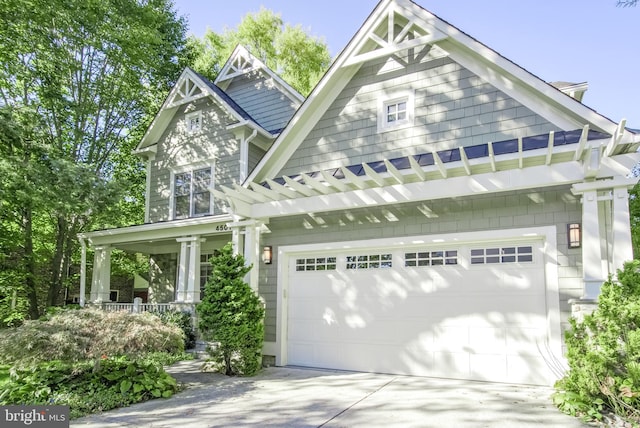 craftsman house featuring a porch and a garage