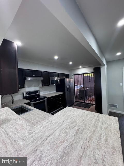 kitchen featuring stainless steel appliances, sink, and dark hardwood / wood-style flooring