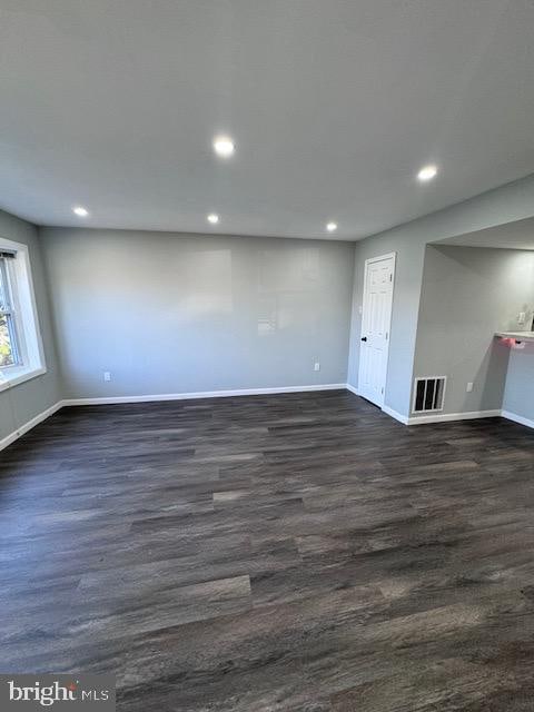 basement with dark hardwood / wood-style flooring