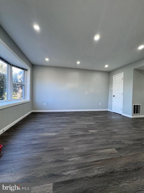 spare room featuring dark hardwood / wood-style floors