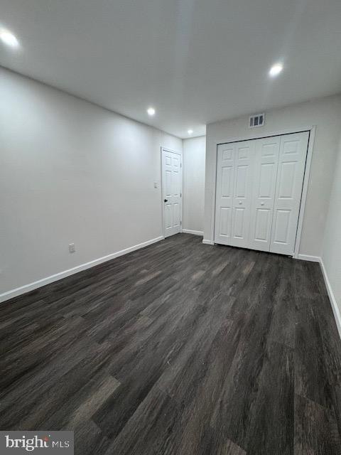 interior space with a closet and dark hardwood / wood-style floors