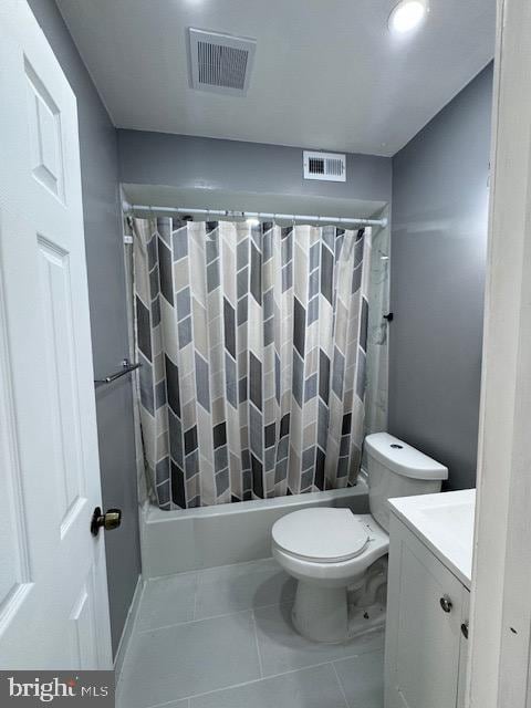 full bathroom with vanity, shower / tub combo with curtain, toilet, and tile patterned floors