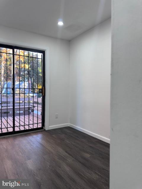 spare room with dark wood-type flooring