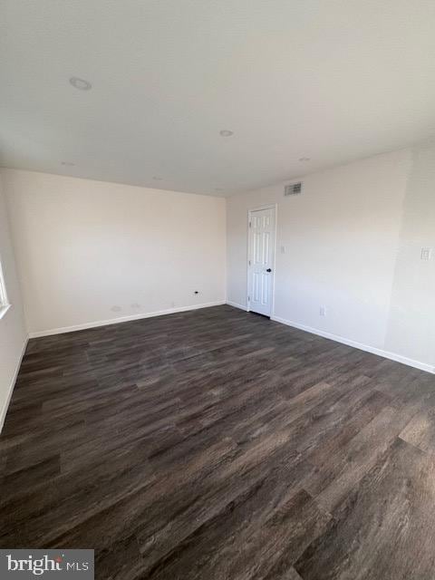 unfurnished room featuring dark hardwood / wood-style flooring