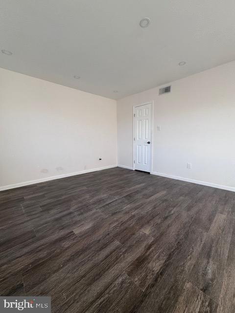 empty room featuring dark hardwood / wood-style floors