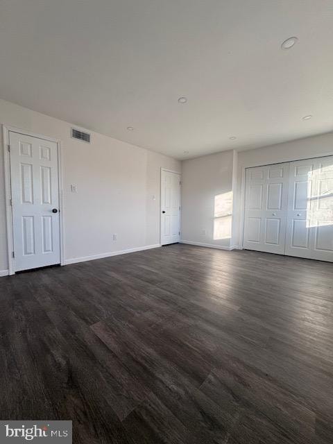 unfurnished bedroom featuring dark hardwood / wood-style flooring