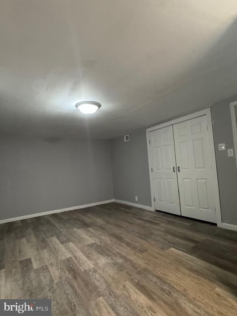 interior space with a closet and dark hardwood / wood-style floors