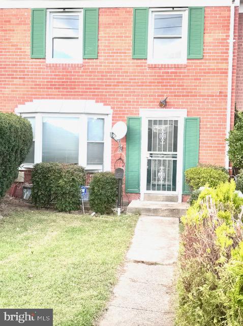 doorway to property with a lawn