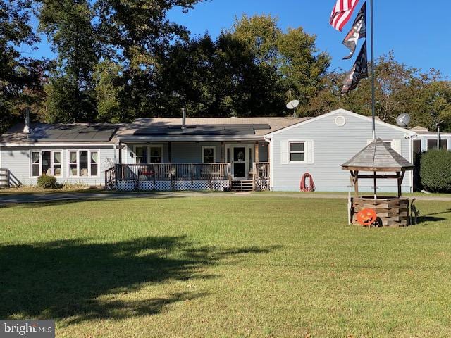 back of property featuring a gazebo, a deck, and a yard