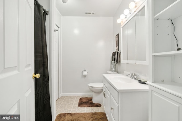 bathroom with vanity, toilet, and tile patterned floors